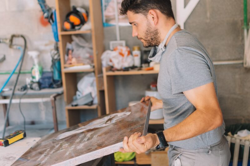 Caucasian man preparing a tombstone for sculpting on a working day
